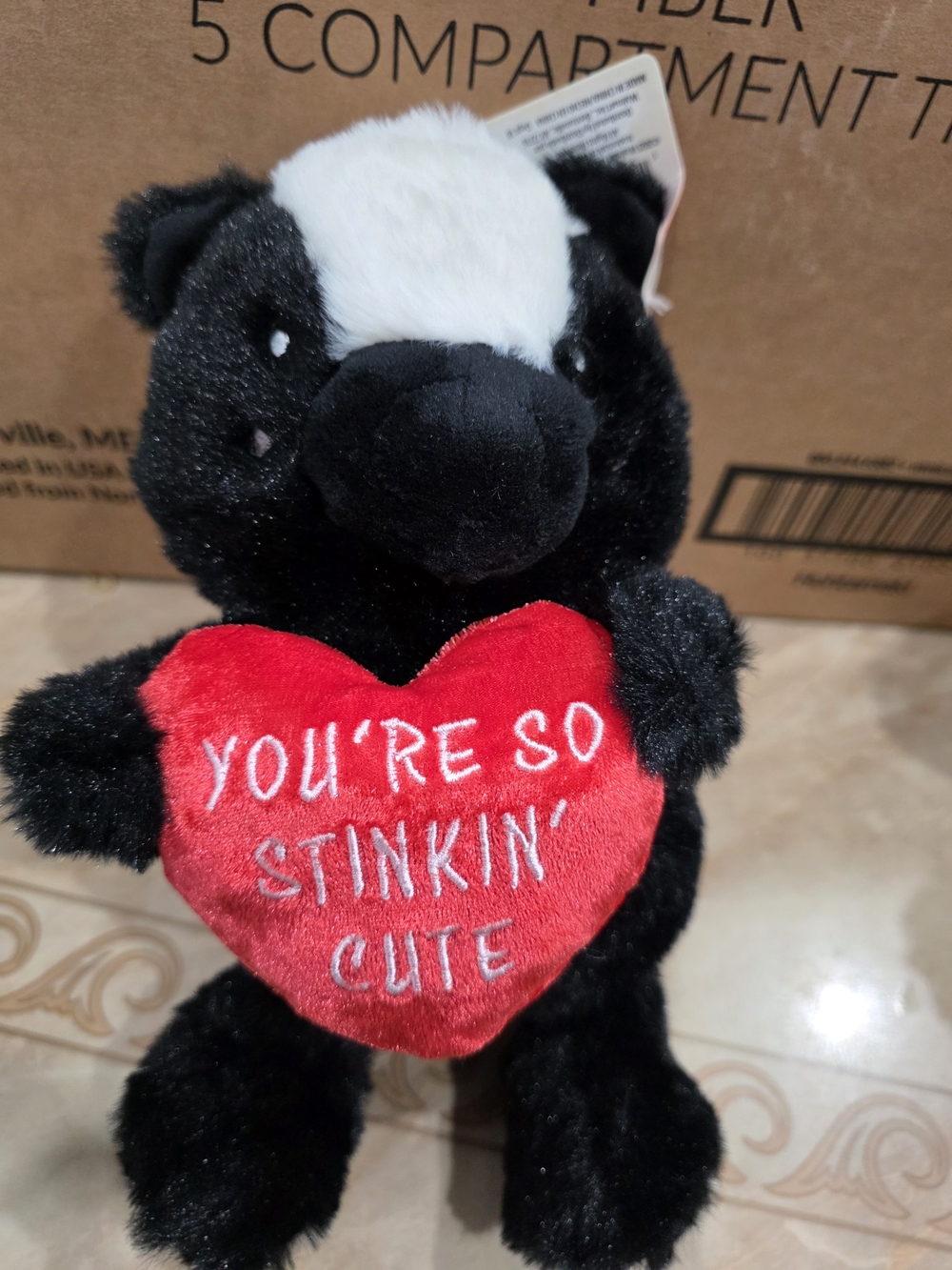 Black & White Plush Skunk Holding Red Heart